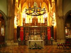 The sanctuary: the corona hangs above the altar, with the cathedra behind.